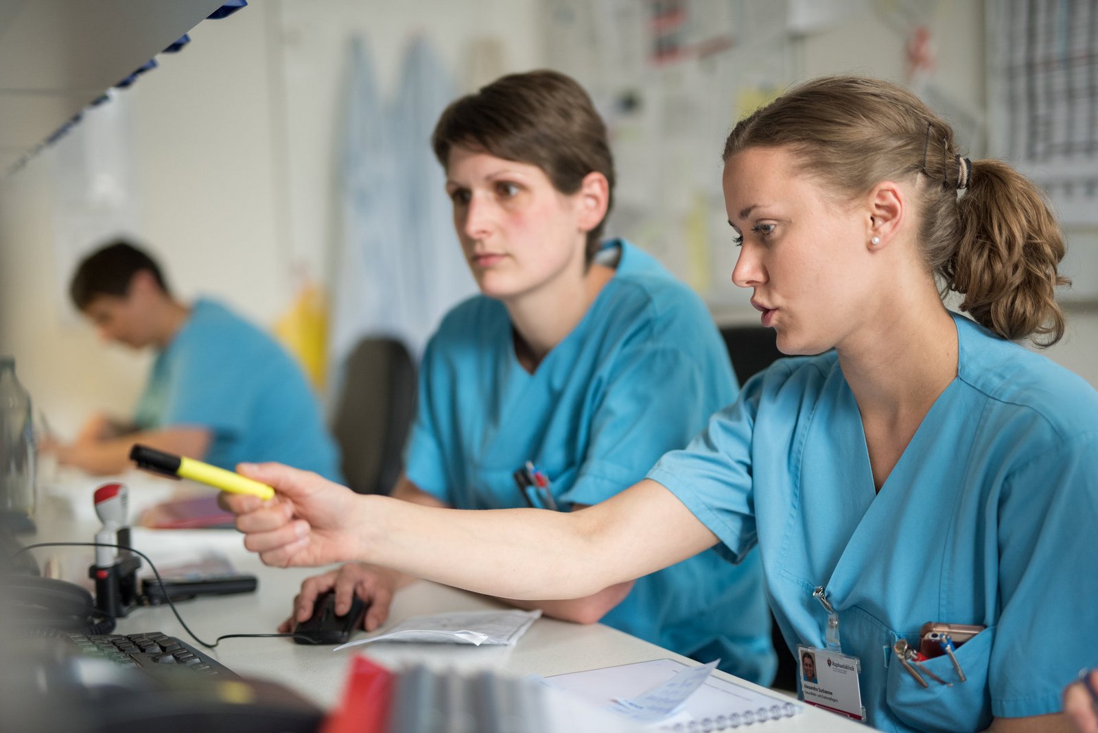 Pflegerinnen besprechen sich am Computer